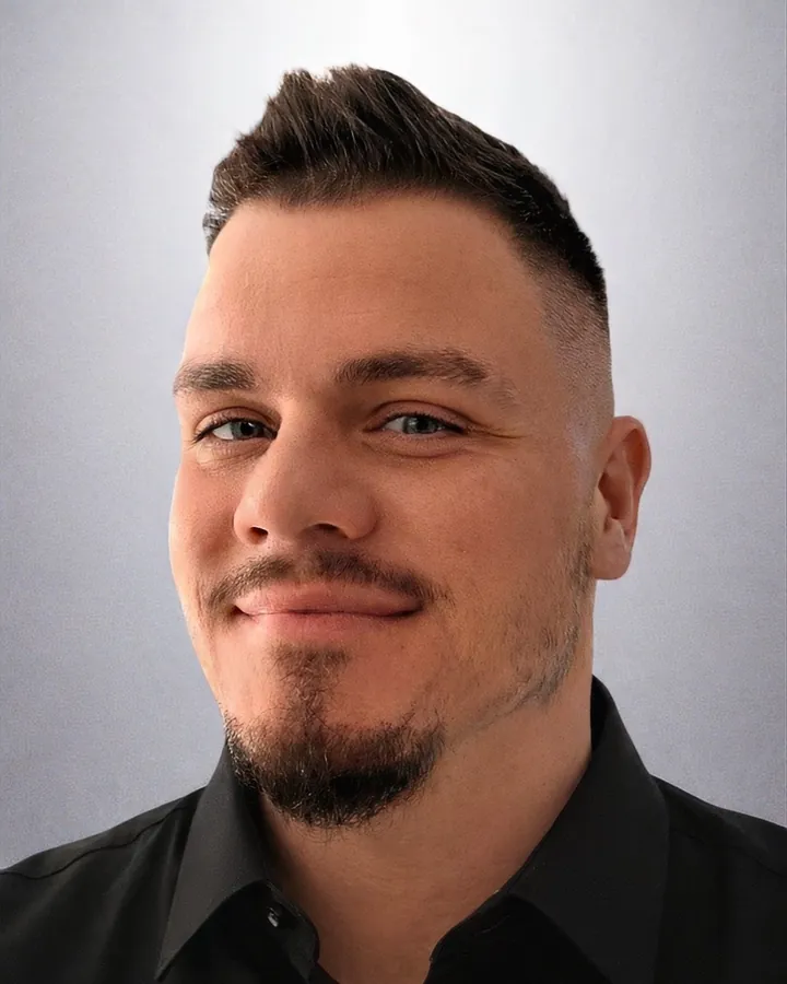 Dariusz Zalewski in a black shirt against a light grey background